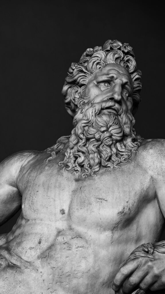 Marble philosopher statue illuminated against shadow